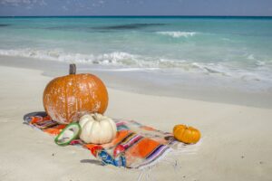 pumpkins on a towel on the beach